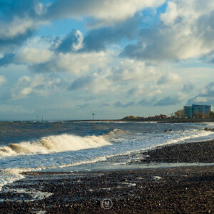Coastal Waves Under a Cloudy Sky