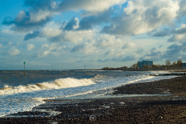 Coastal Waves Under a Cloudy Sky